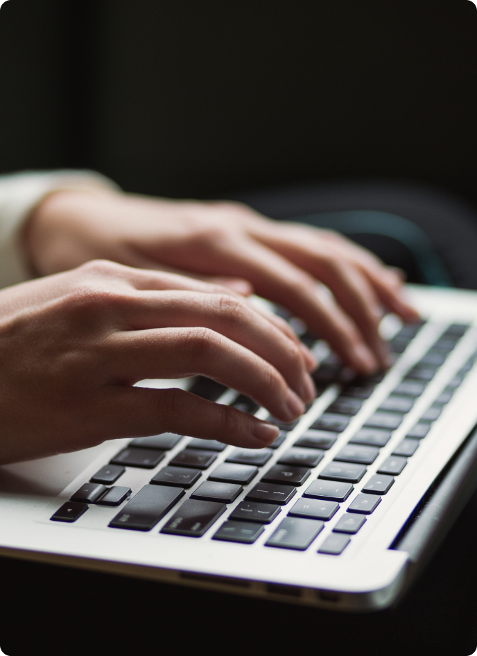 A happy psychologist reading about upcoming features and new psychological assessments that will soon become available on the Measurely software platform.